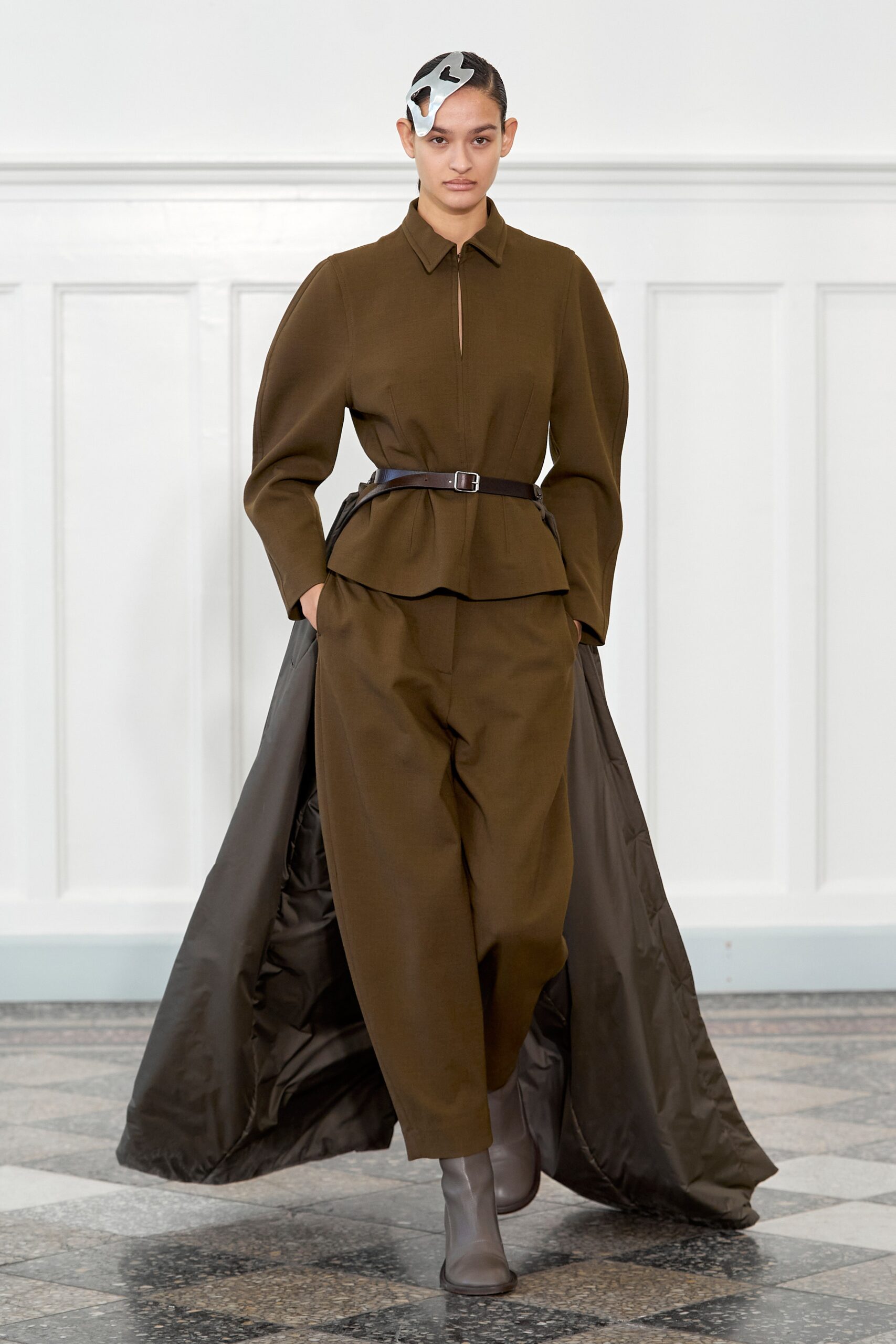A relaxed brown coat with long sleeves and a collared design paired with matching pants.