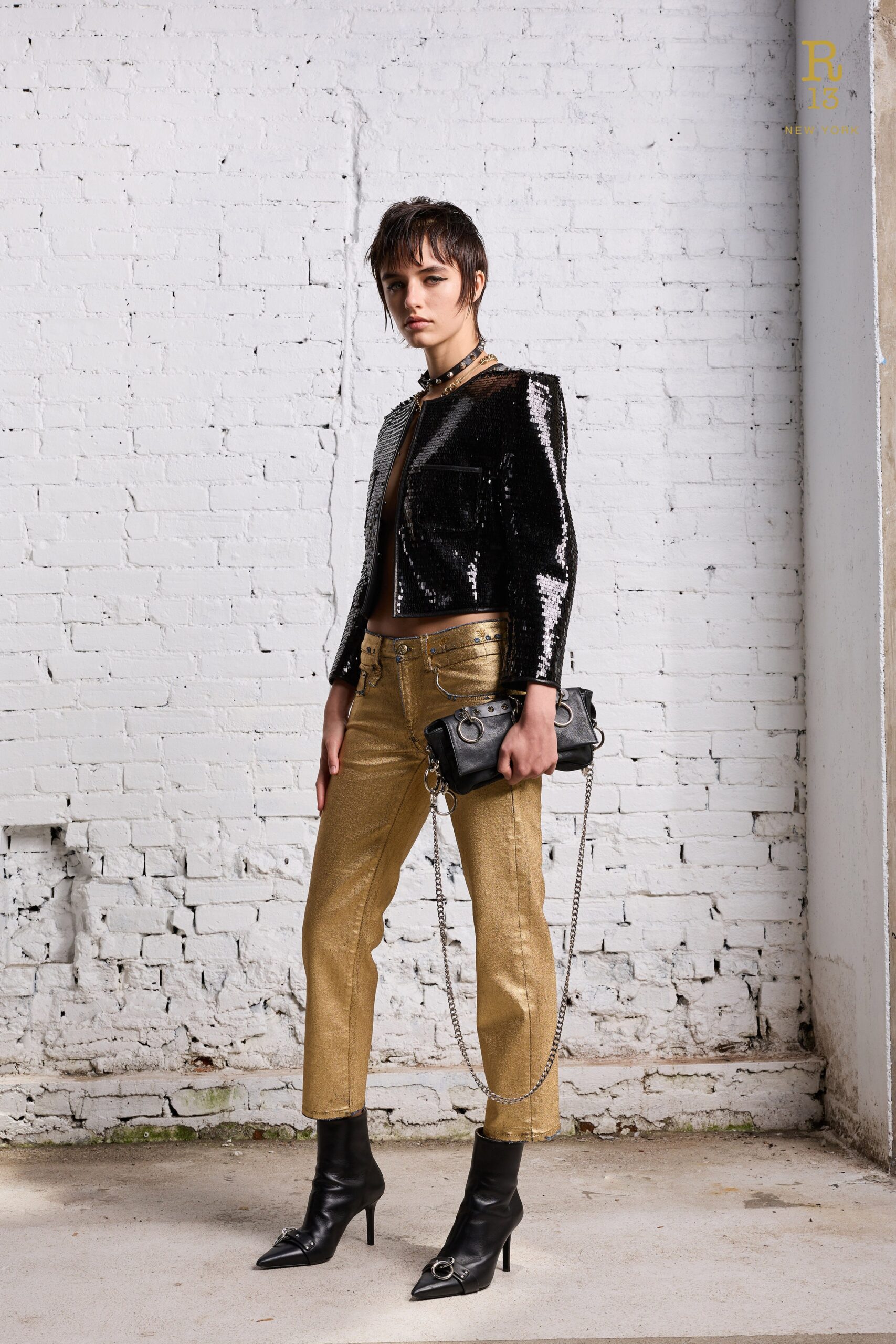 A fitted black sequined jacket paired with gold straight-leg pants for a chic look.