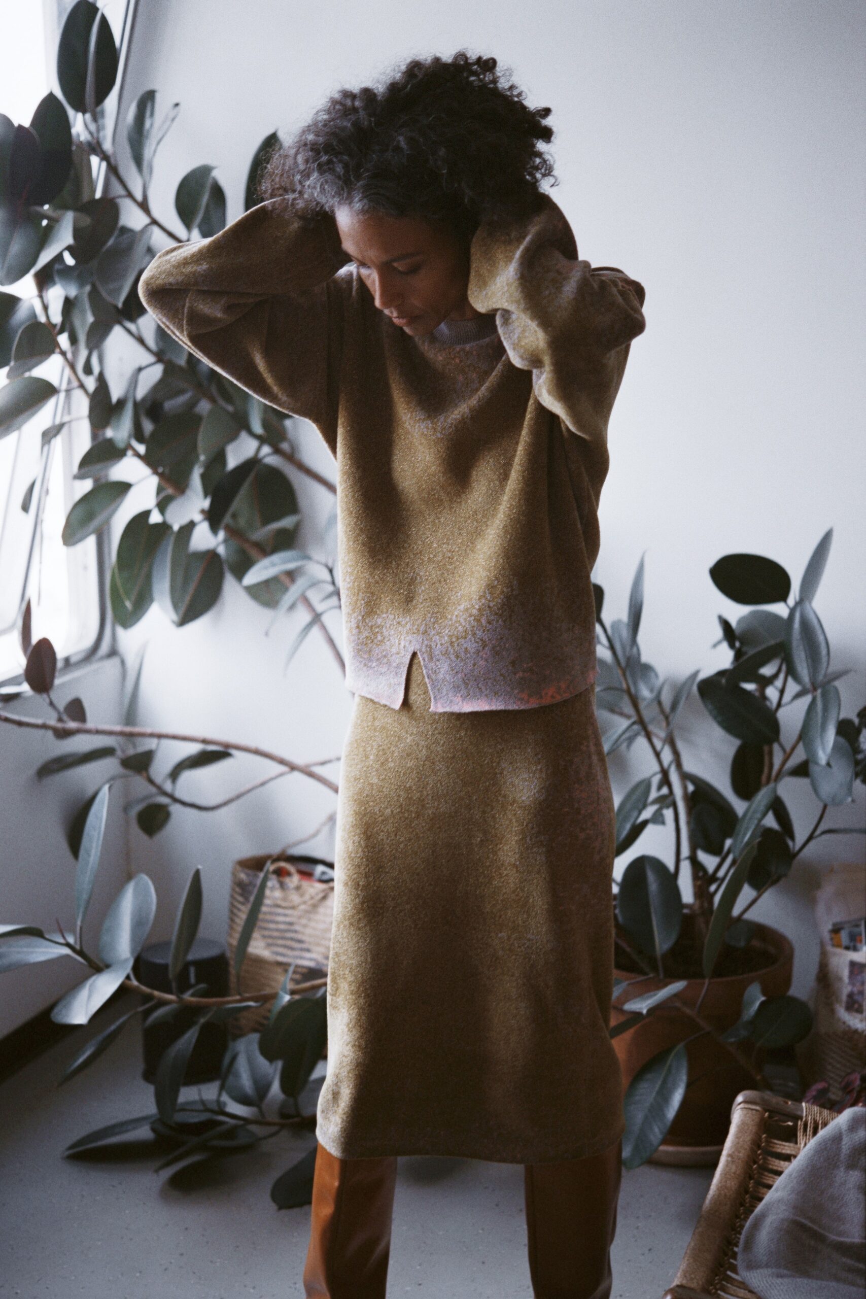 A fitted brown wool long-sleeve top with a collared design paired with a matching skirt.