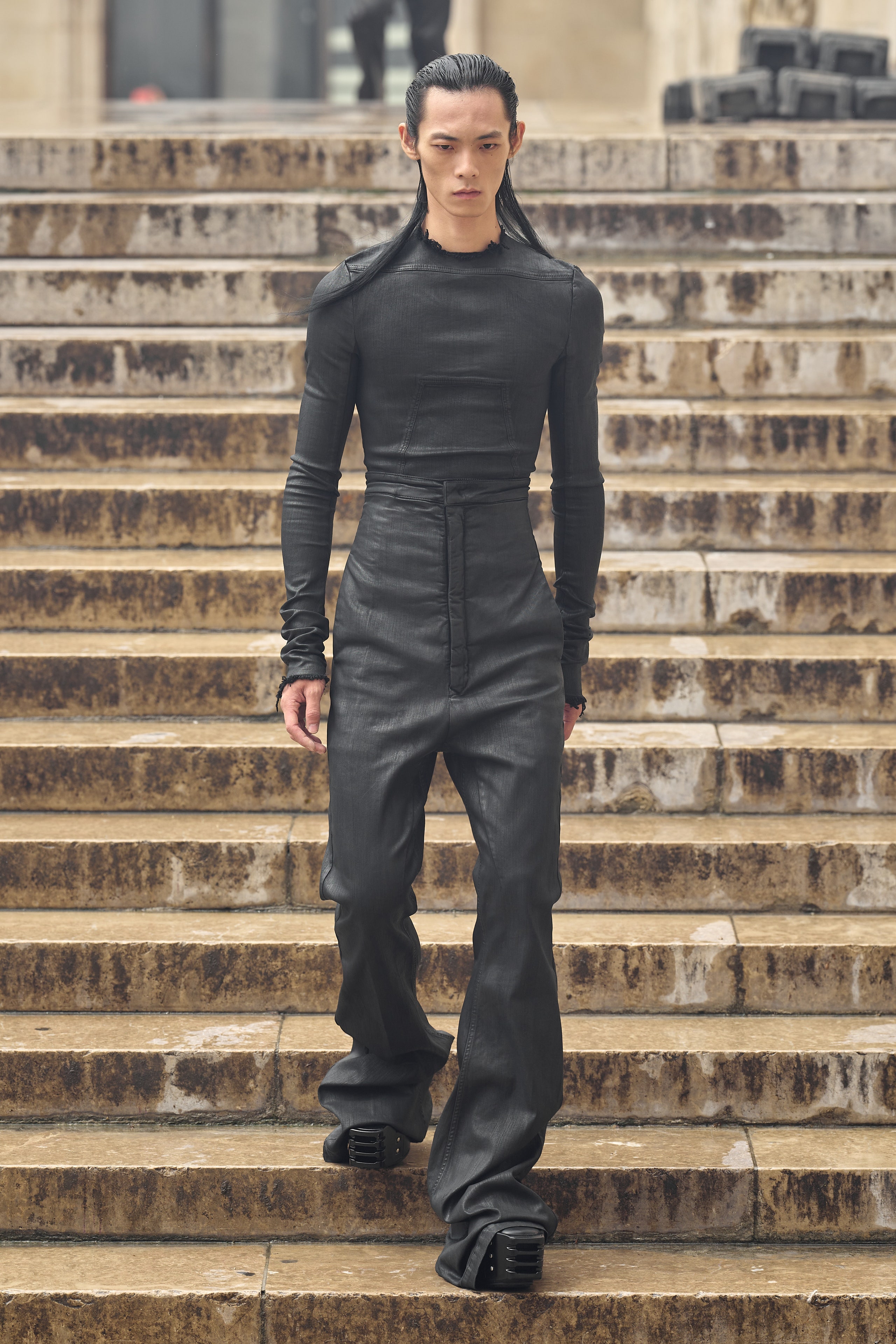 A fitted black cotton long-sleeve top paired with straight-leg pants.