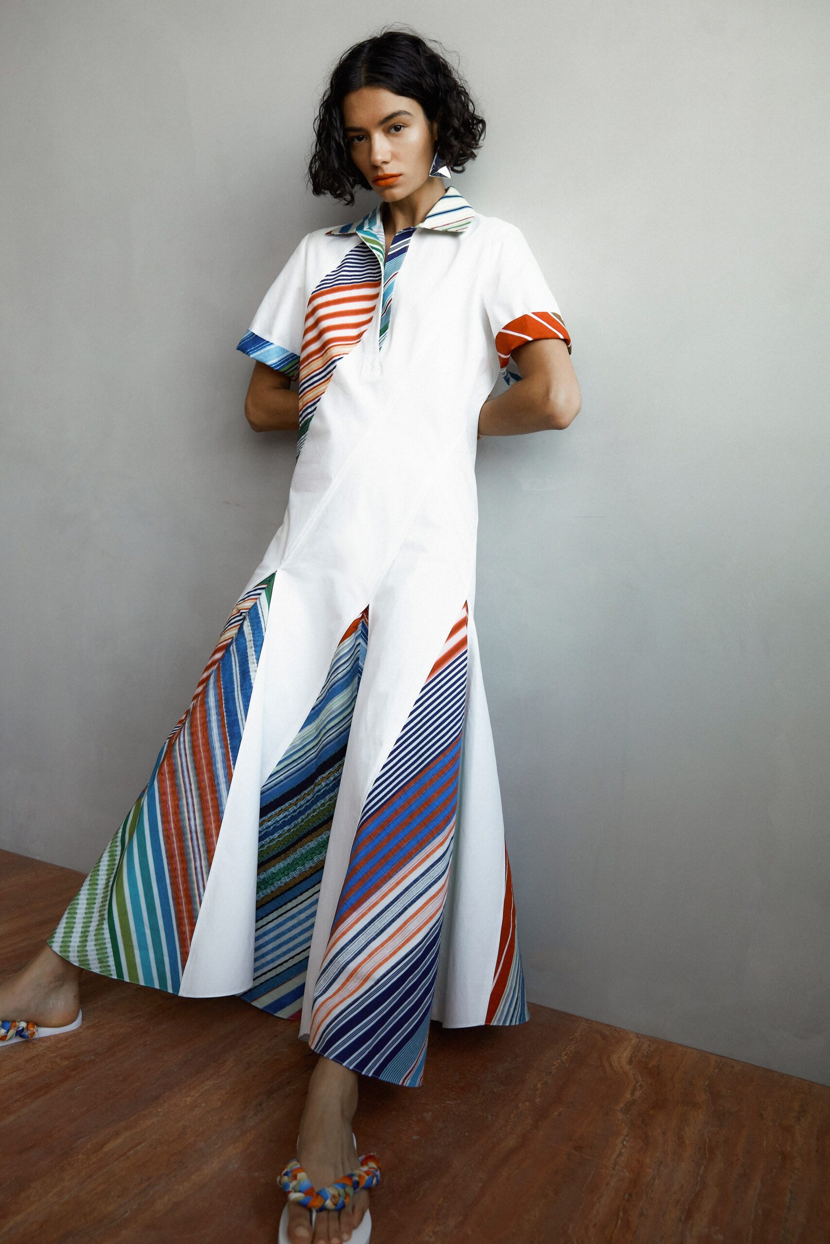 A relaxed white dress with short sleeves, a collared neckline, and color-blocked asymmetric design.