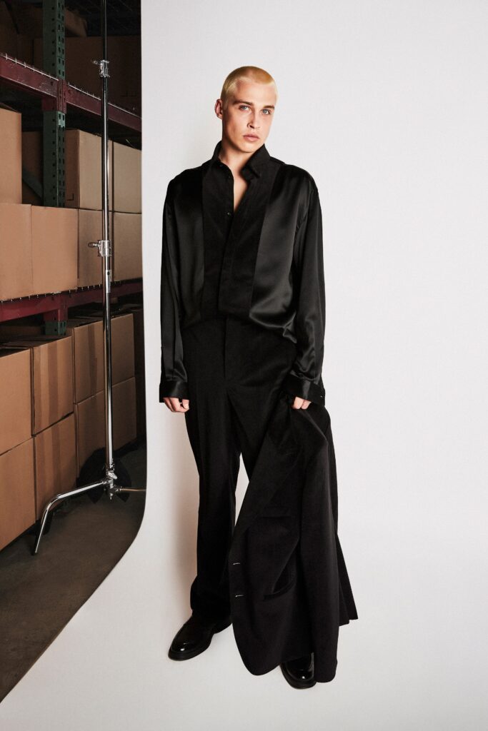 A fitted black silk blazer with long sleeves and straight-leg pants for a sleek look.