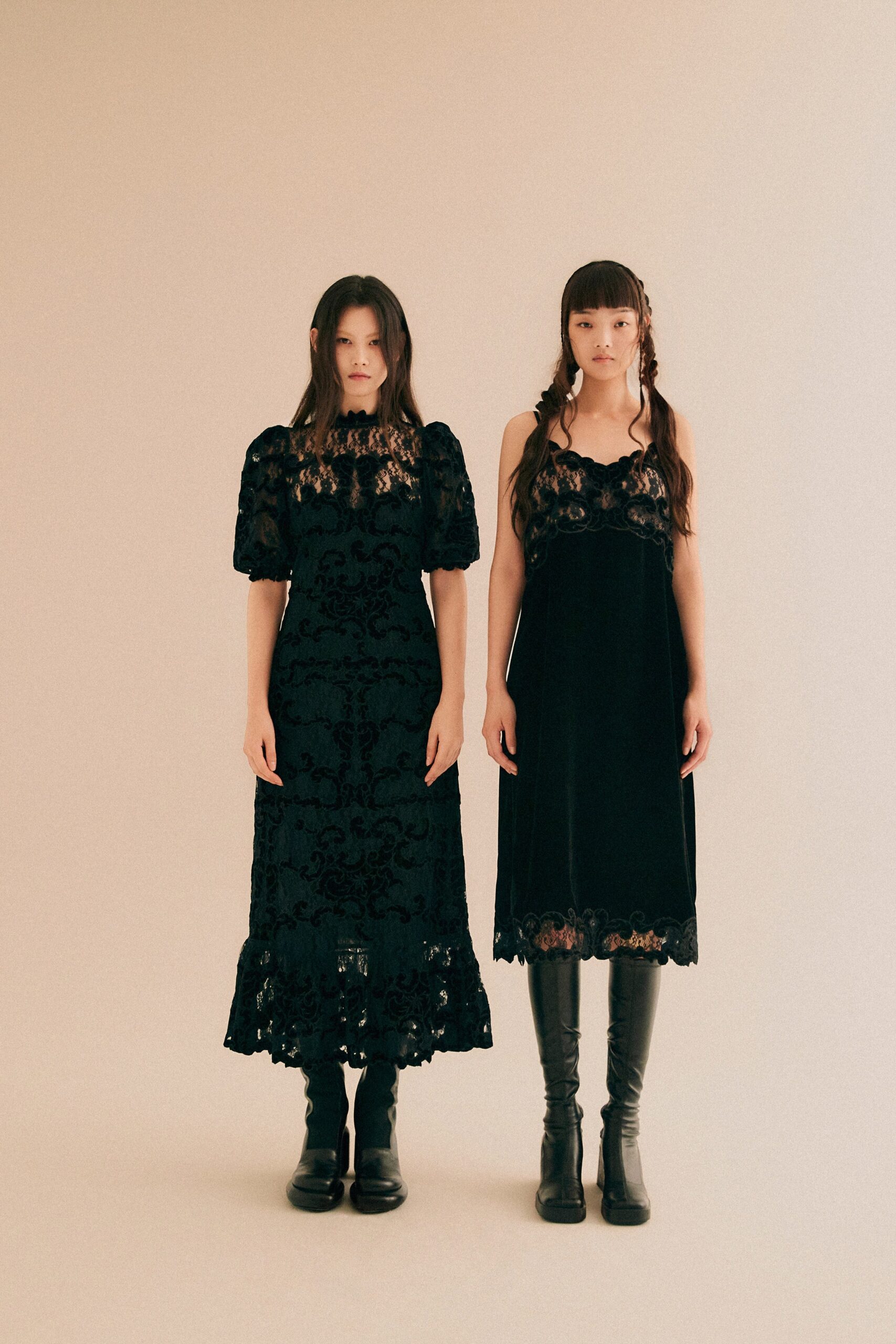 A fitted black velvet sleeveless dress with an embroidered design and V-neckline.