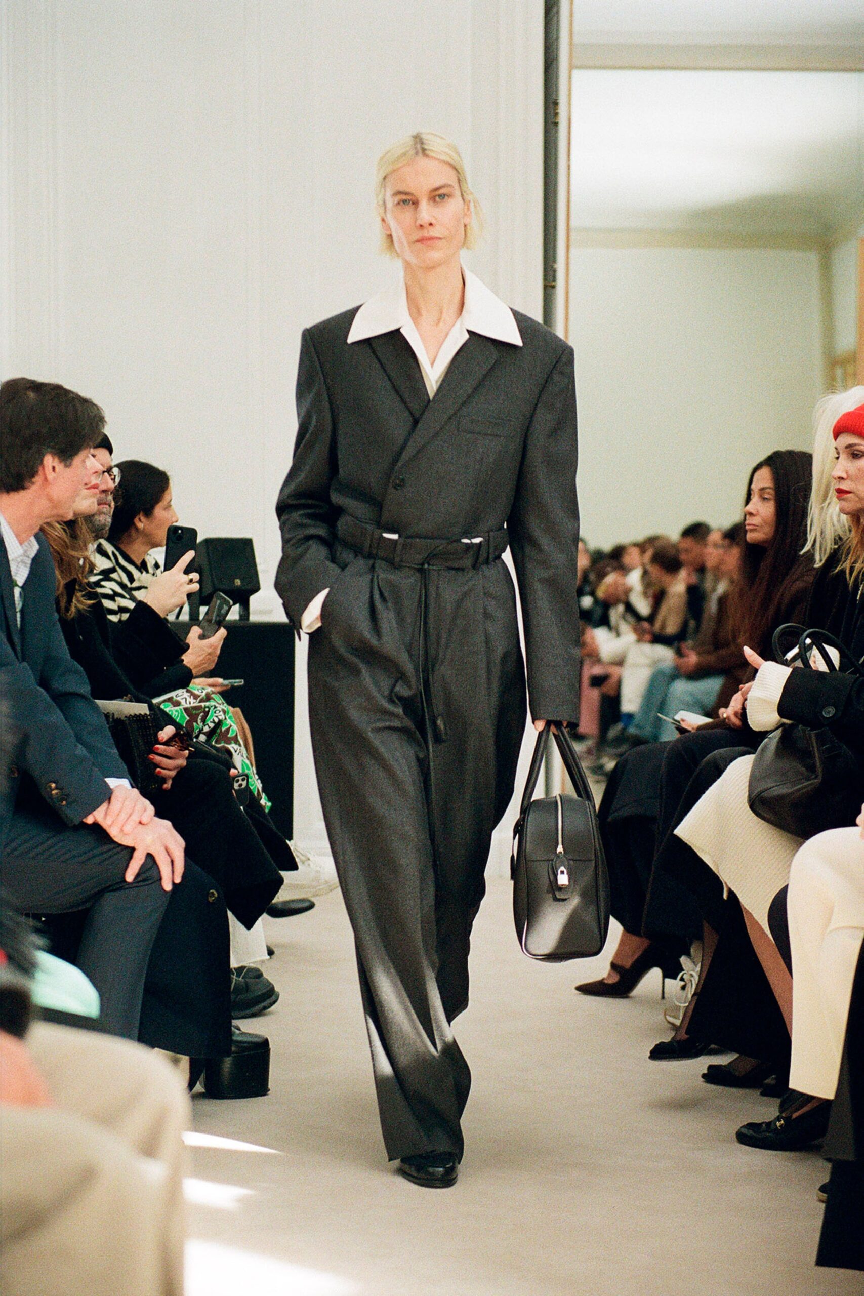 A tailored gray wool suit with a collared long-sleeve top and wide-leg trousers.