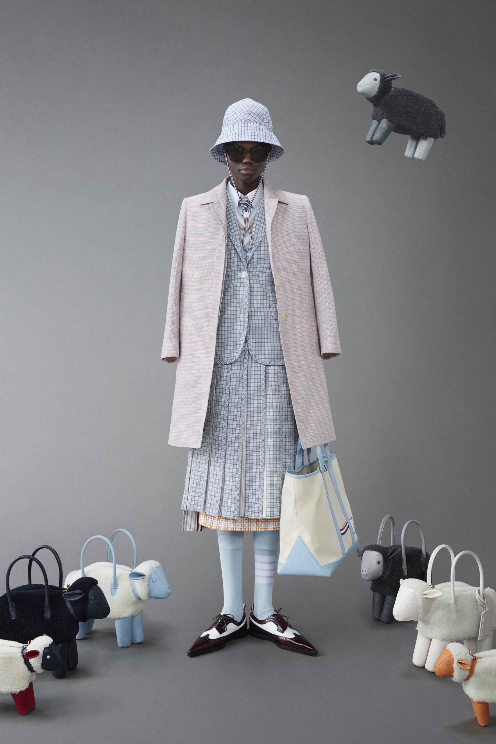 A fitted gray checked coat layered over a blue vest with a collared neckline.
