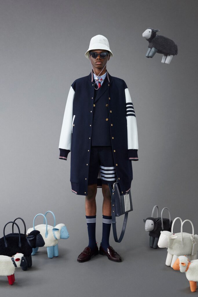 A relaxed navy cotton jacket with short sleeves and striped shorts, perfect for a casual look.