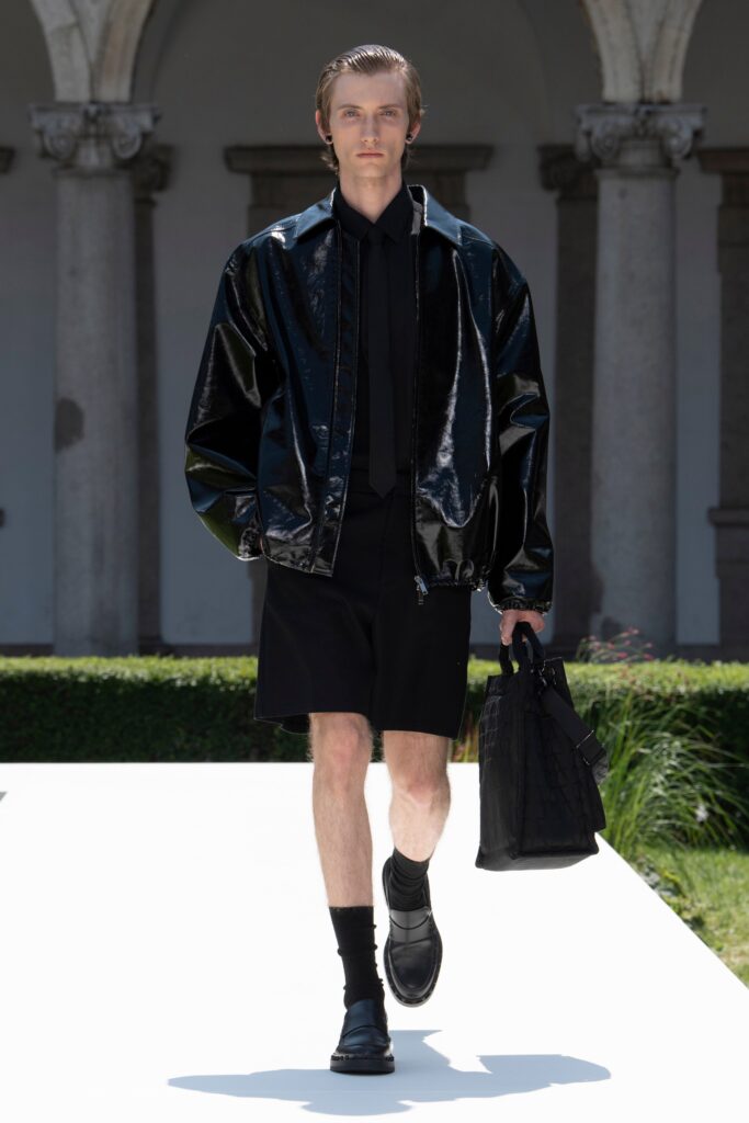 A relaxed black leather long-sleeve jacket paired with matching shorts featuring a zippered detail.