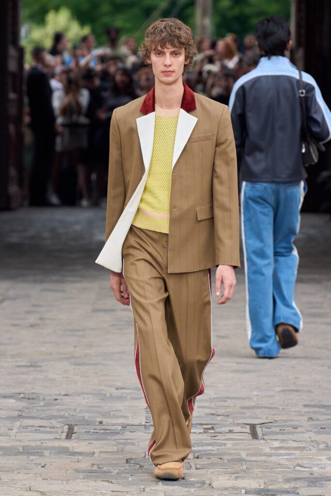A tailored brown suit featuring a yellow top and striped detailing, perfect for a stylish look.