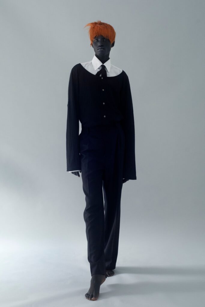 A relaxed black shirt with a collar and long sleeves paired with matching black pants.