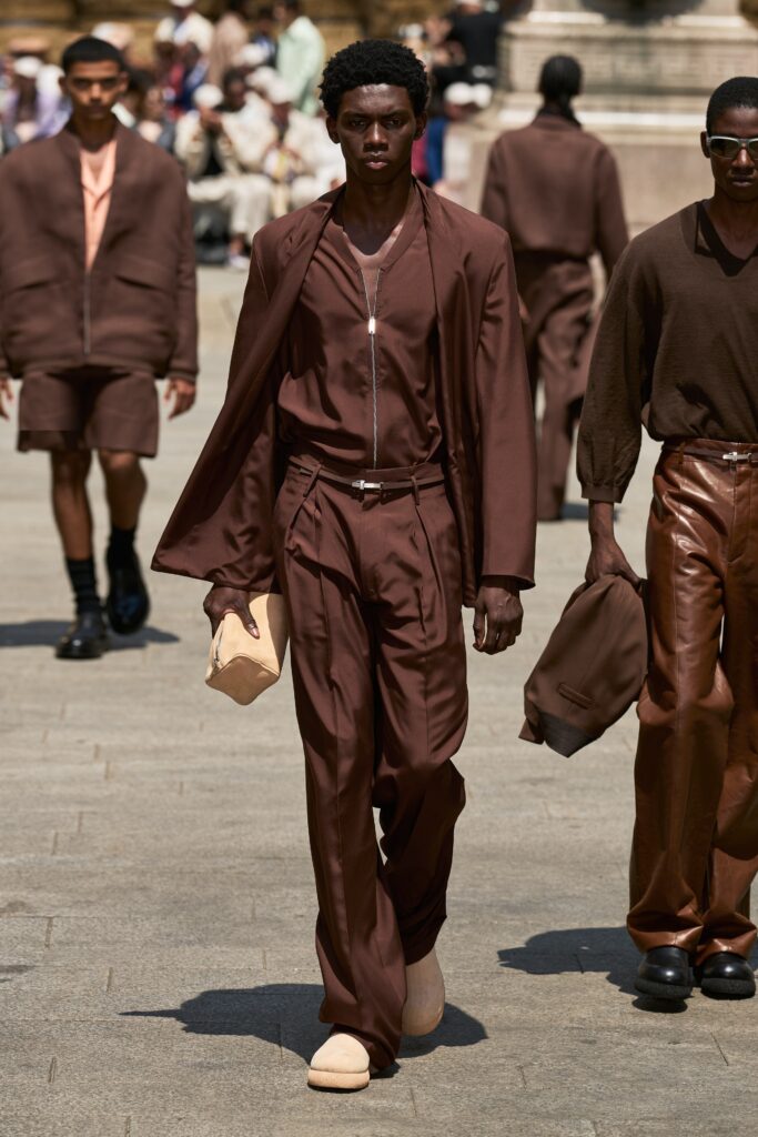 A relaxed brown cotton suit featuring a long-sleeve collared shirt with a zippered detail.