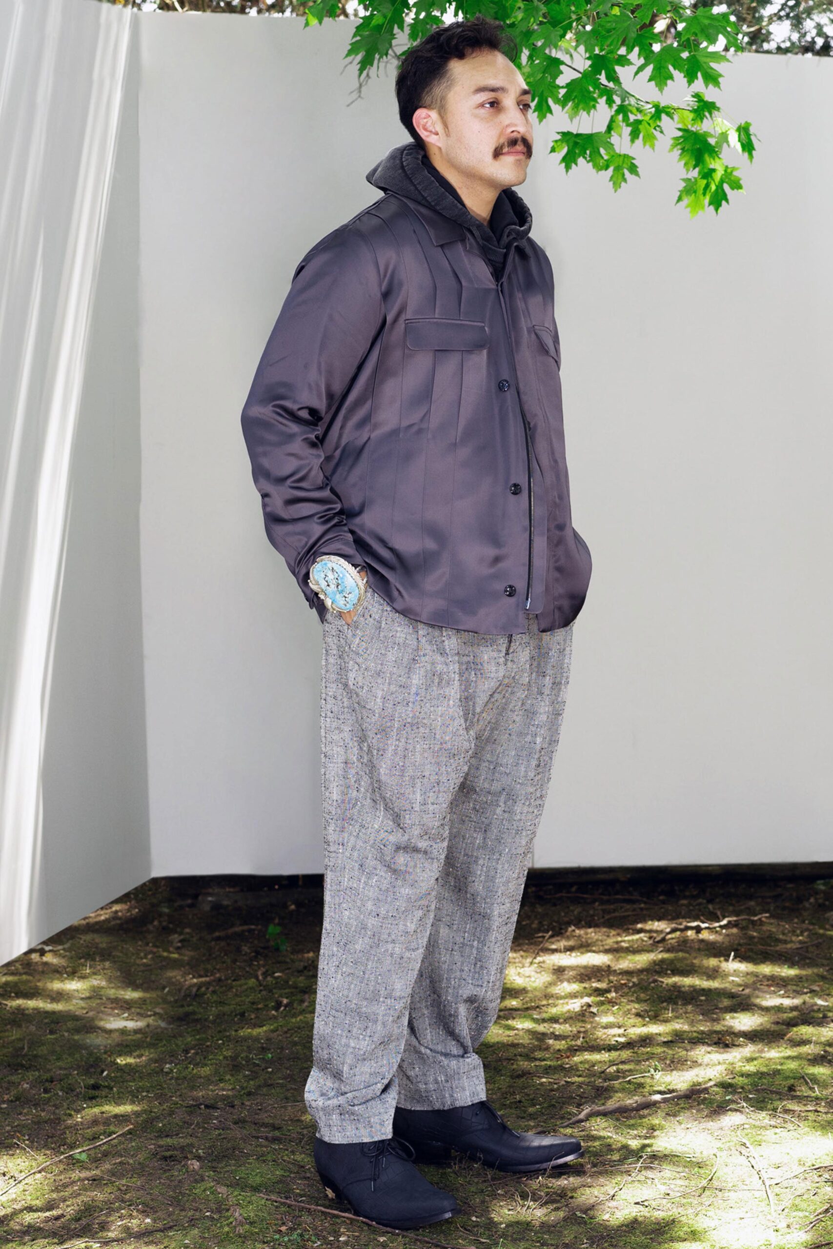 A relaxed gray jacket with long sleeves and collared design paired with straight-leg pants.