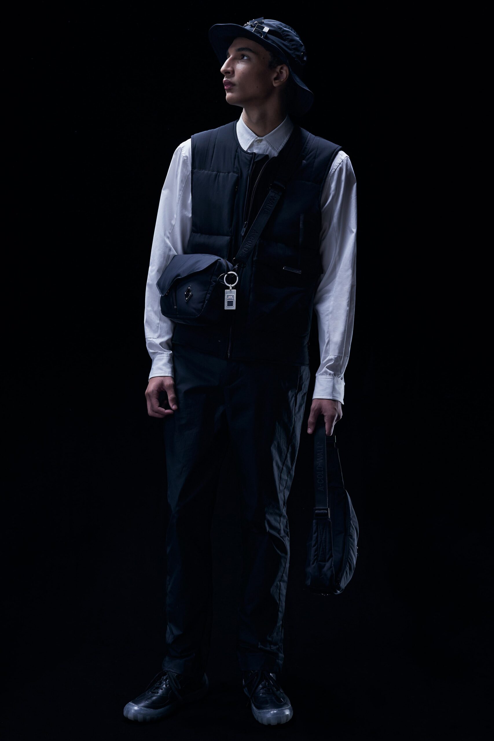 A relaxed black vest paired with long-sleeve collared shirt and matching pants.