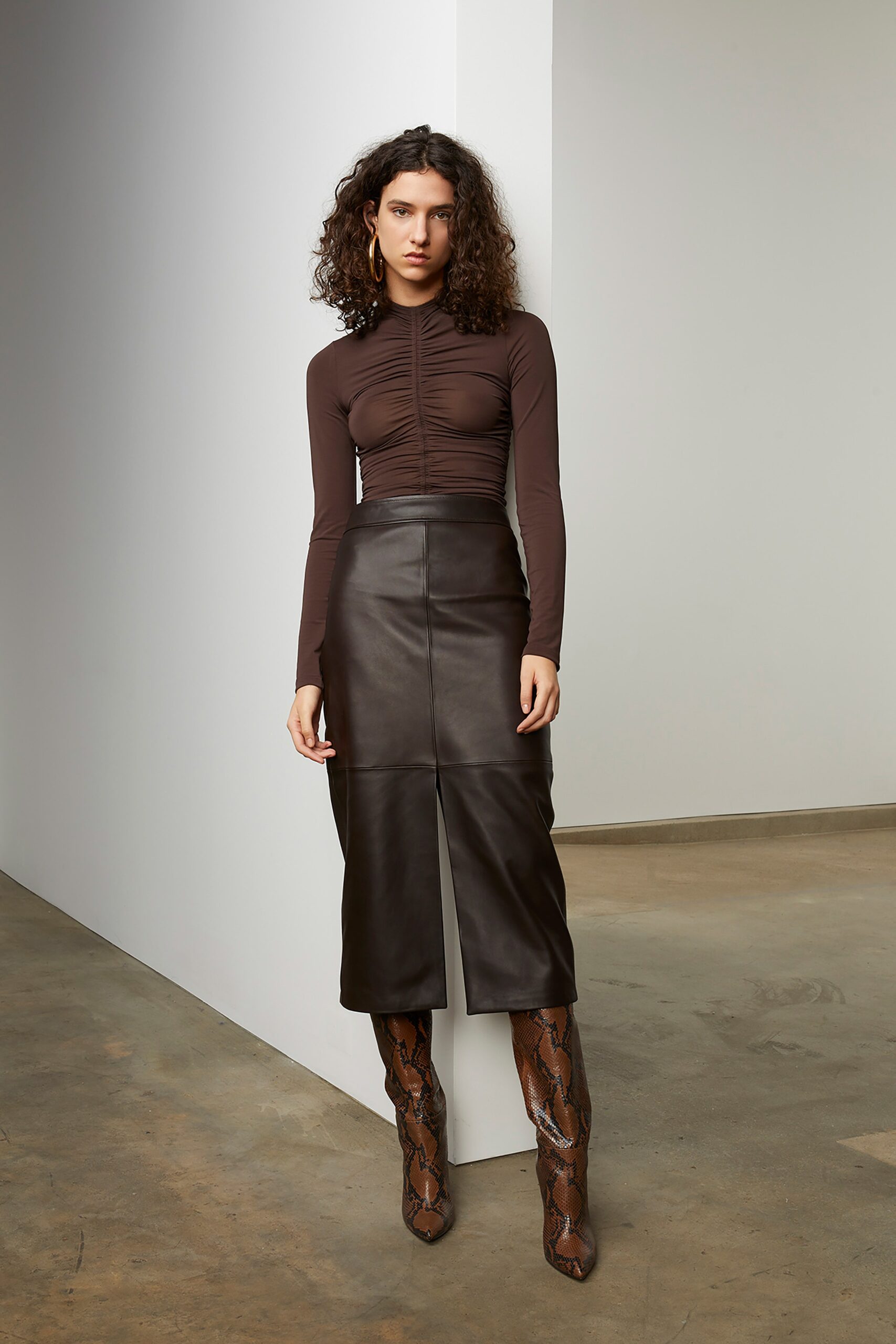 brown fitted top with black leather skirt