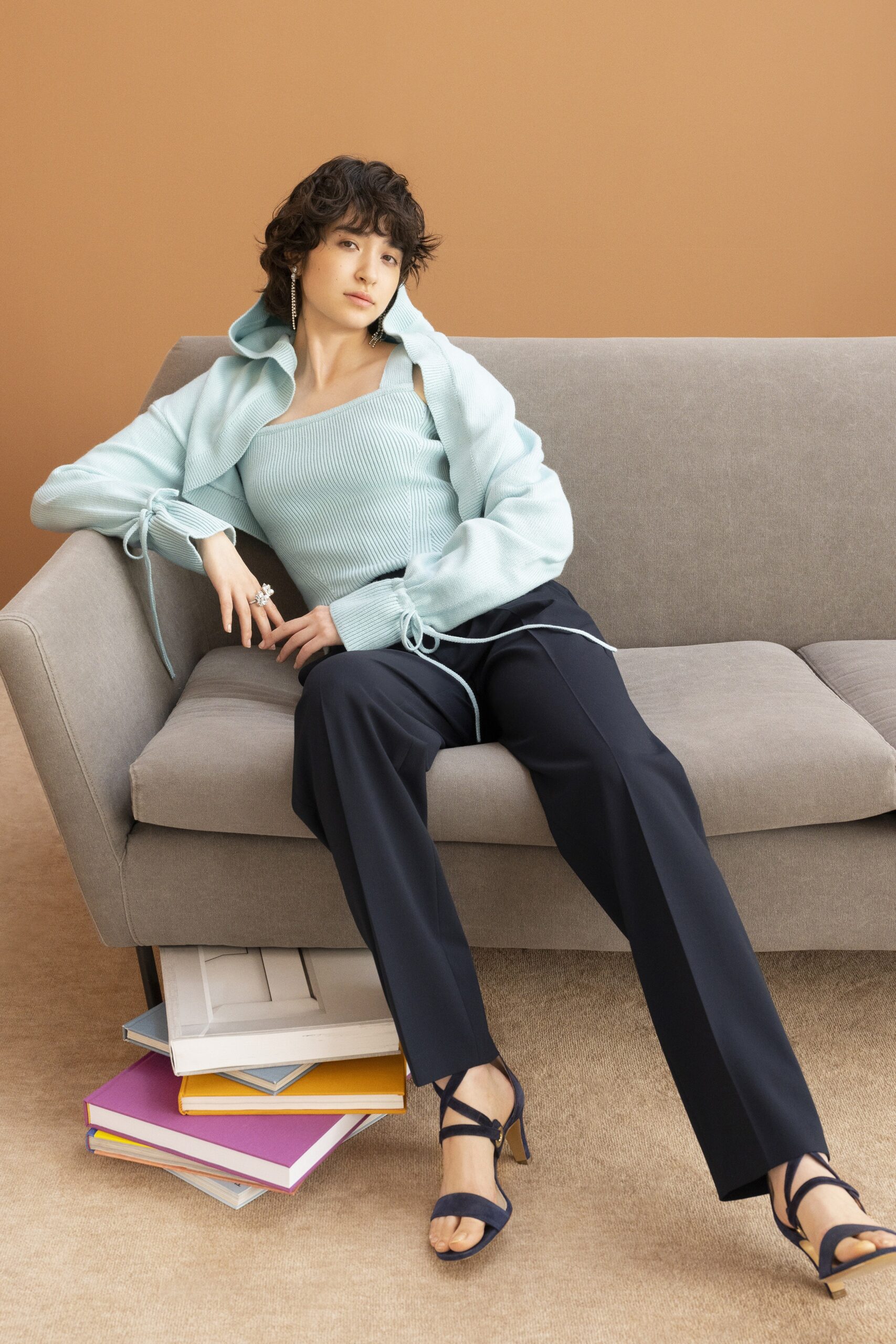 blue fitted top and black tailored pants