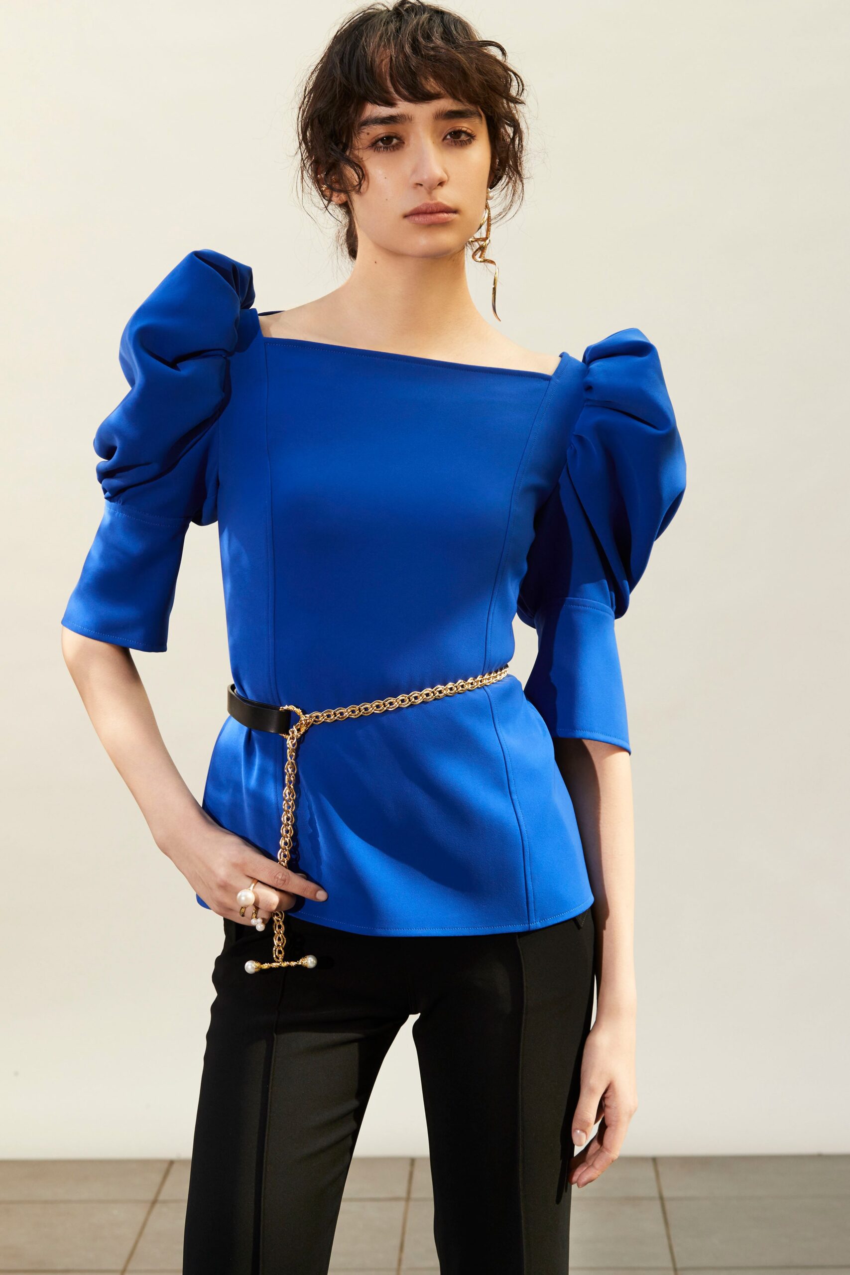 blue off-shoulder top with black pants