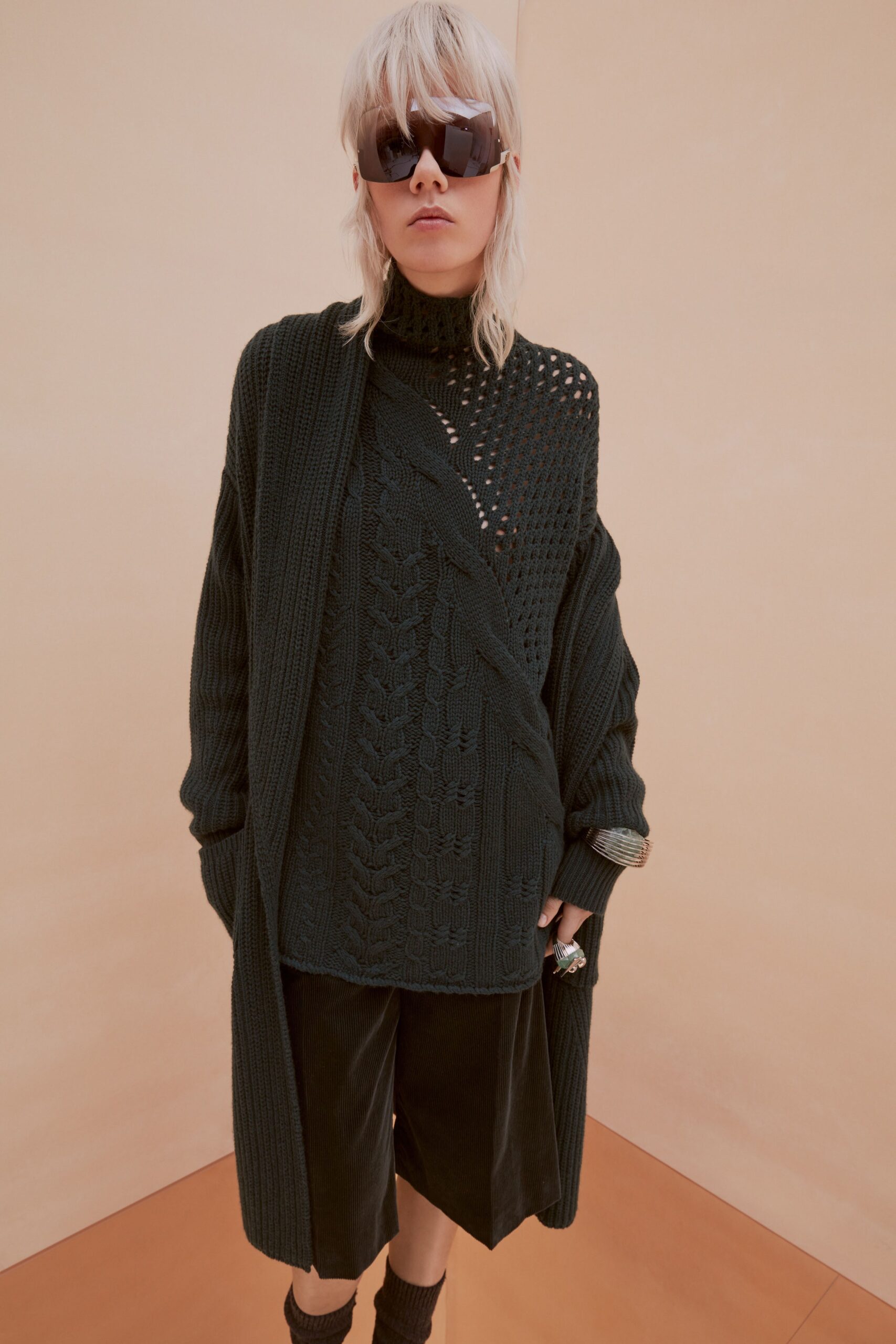 black knit sweater and velvet shorts