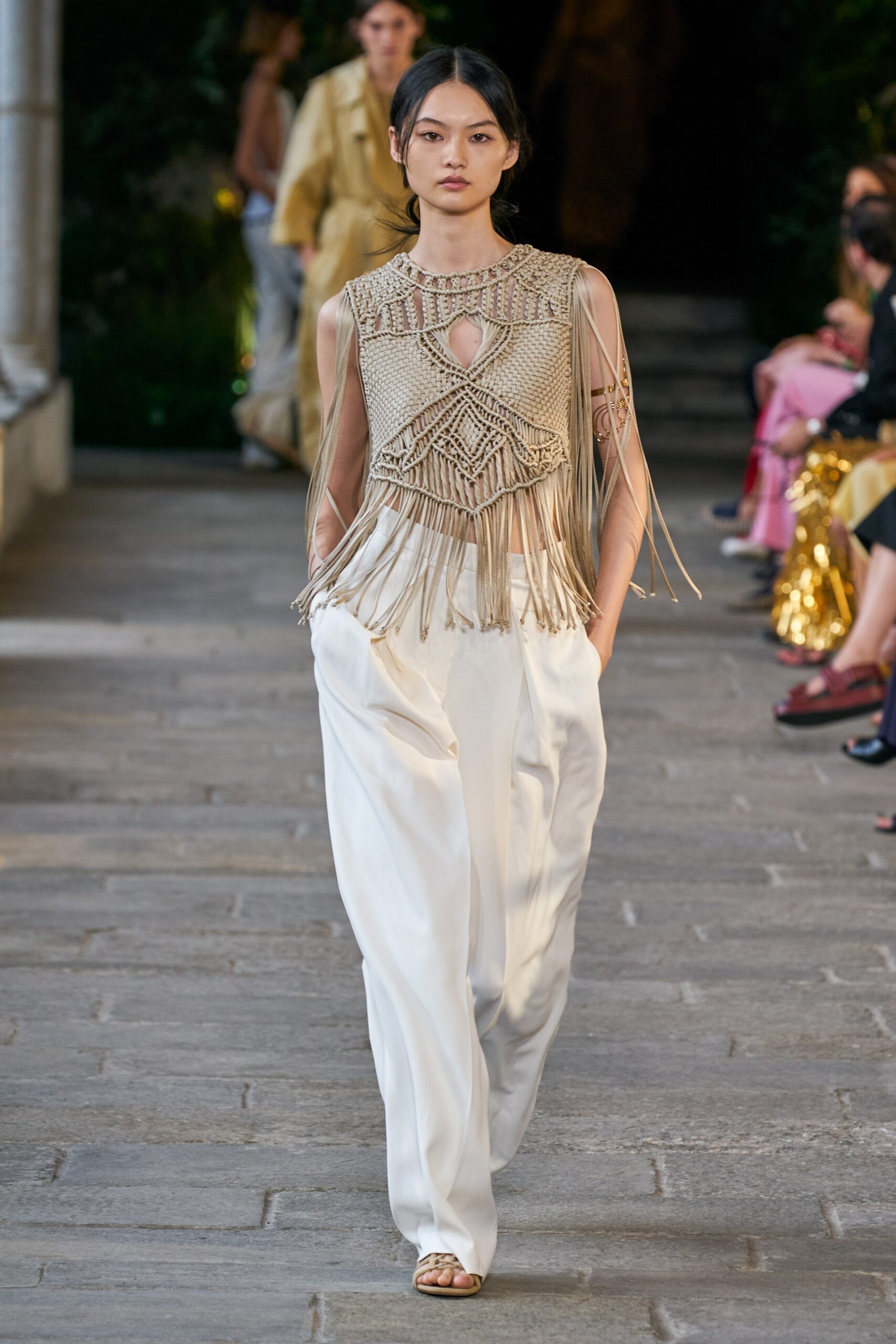 beige fringed top with white pants