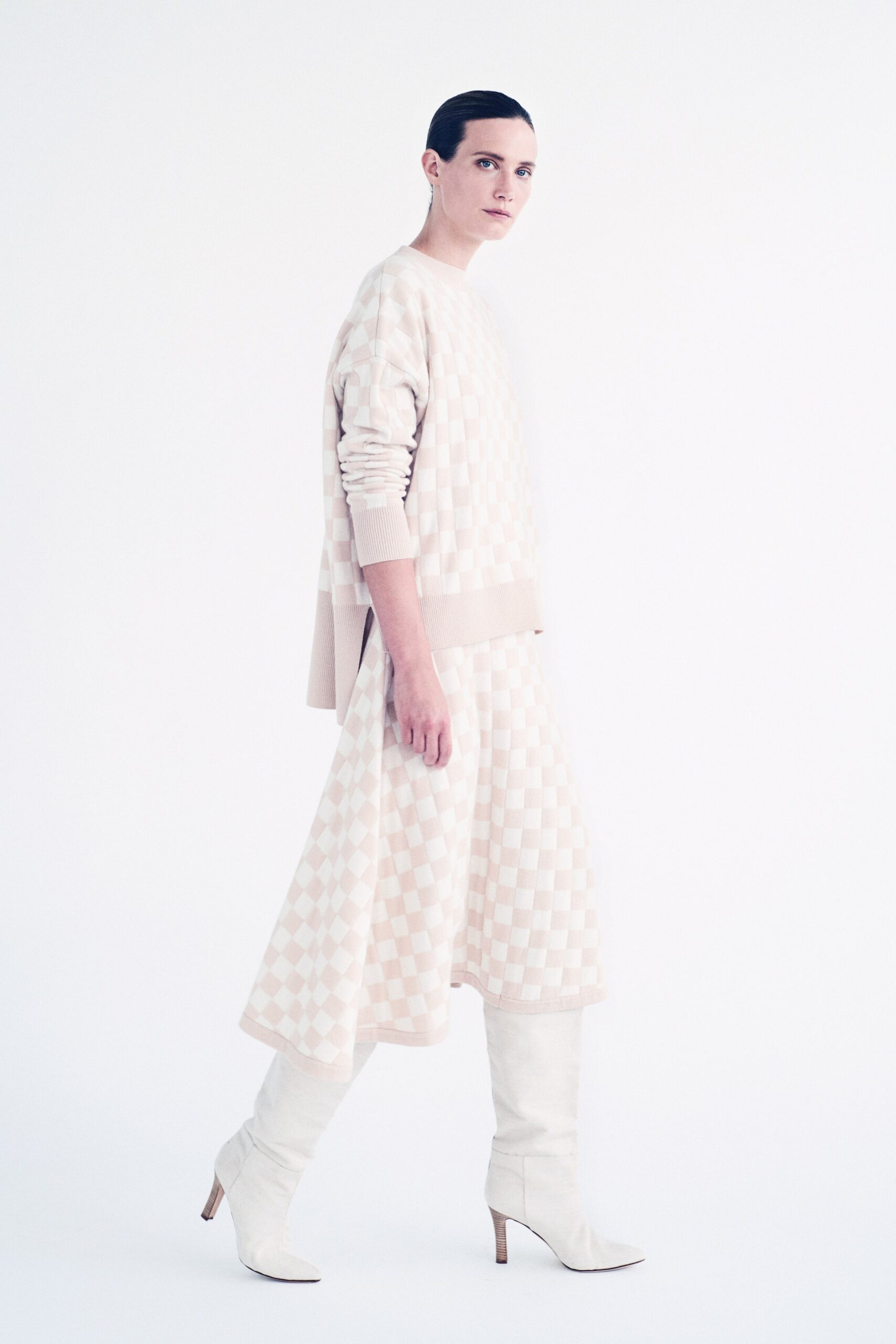 beige pleated midi dress with white boots