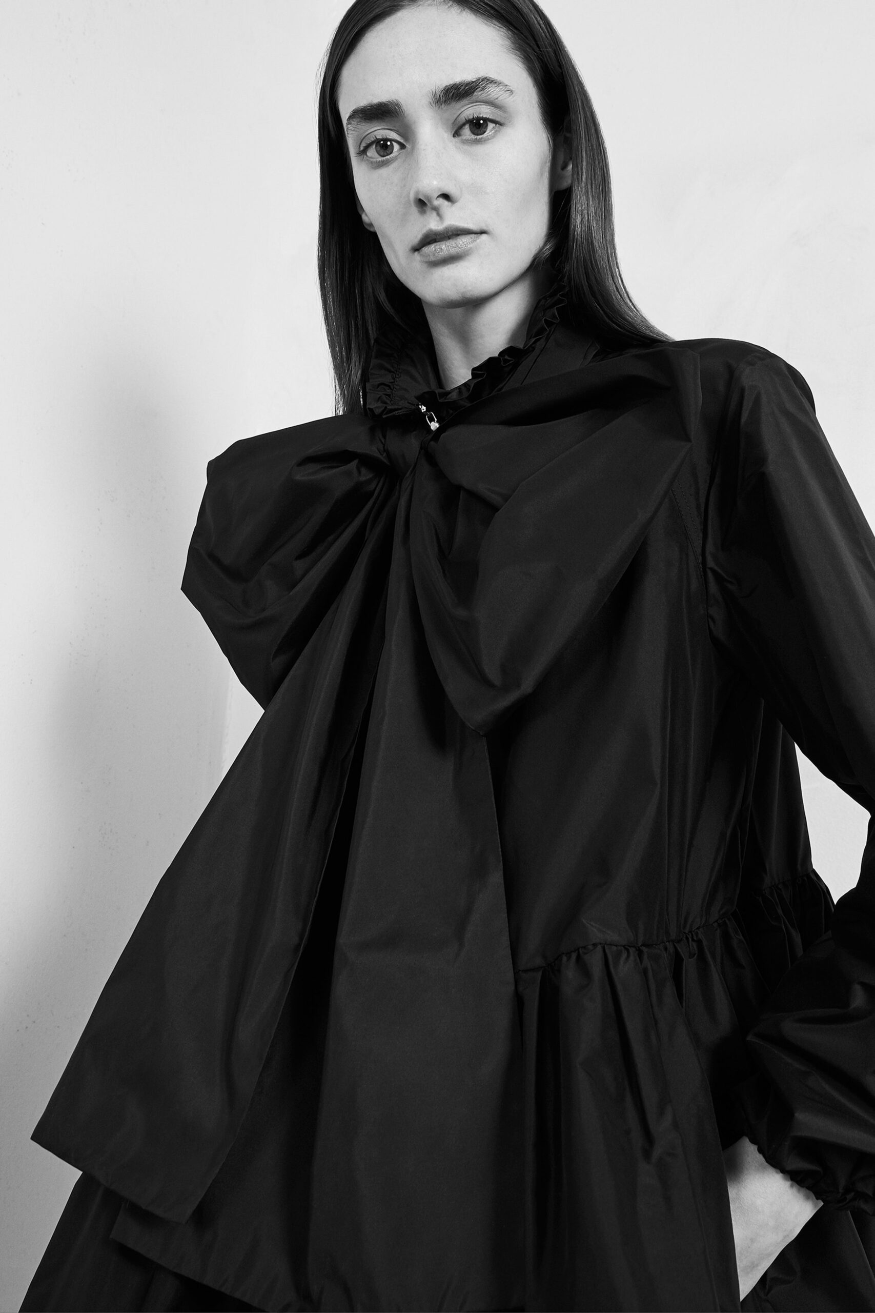 black relaxed coat with draped detail