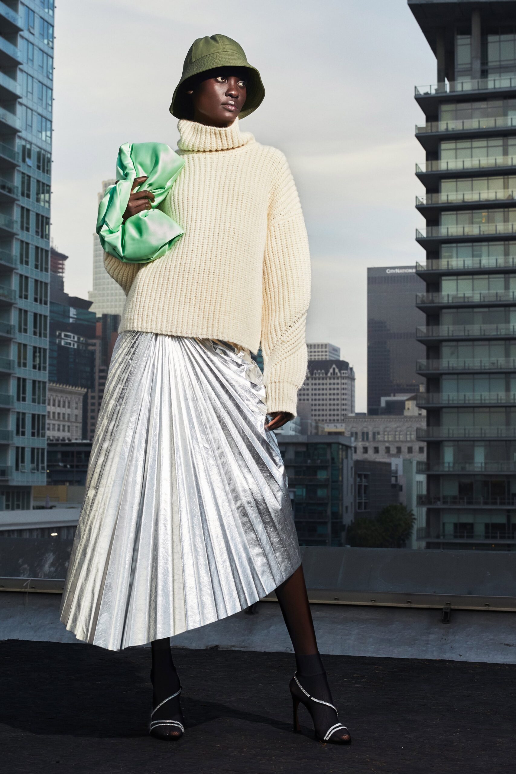 ivory oversized sweater with silver pleated skirt