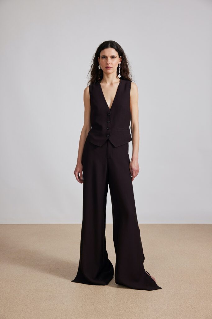 black fitted vest and relaxed pants