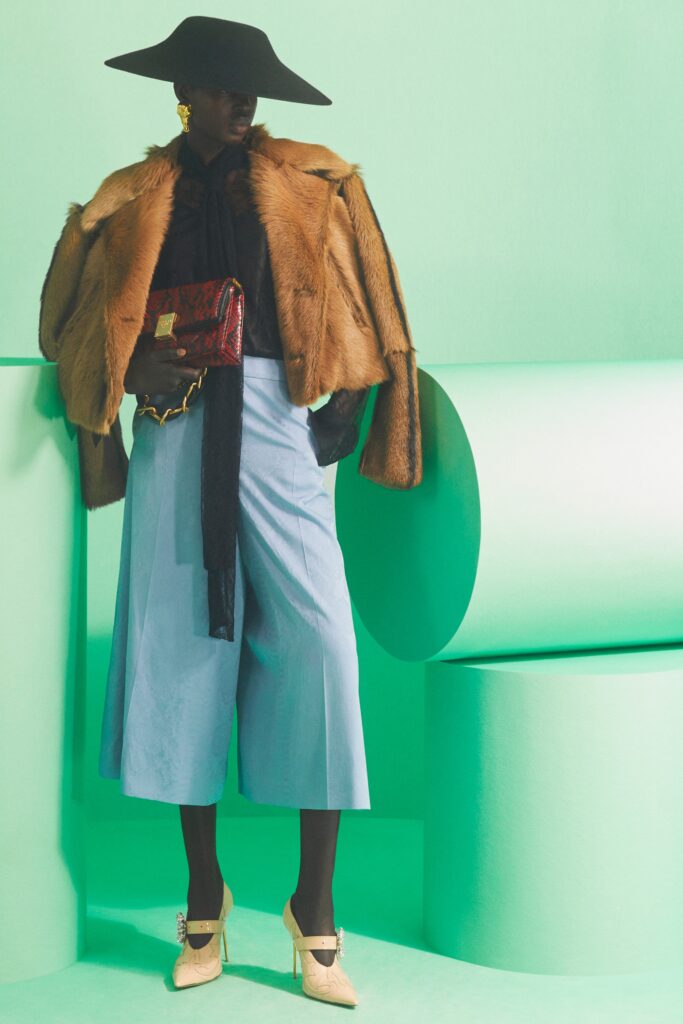 A relaxed brown fur coat paired with wide-leg blue cotton pants.