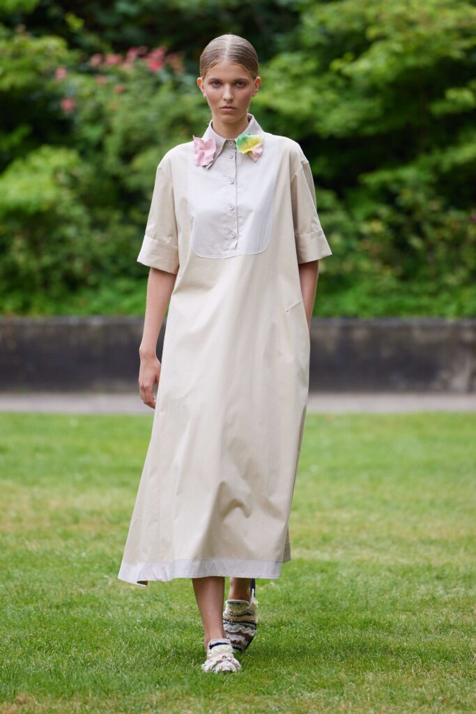 A collared beige cotton dress with short sleeves and a relaxed fit, perfect for casual outings.