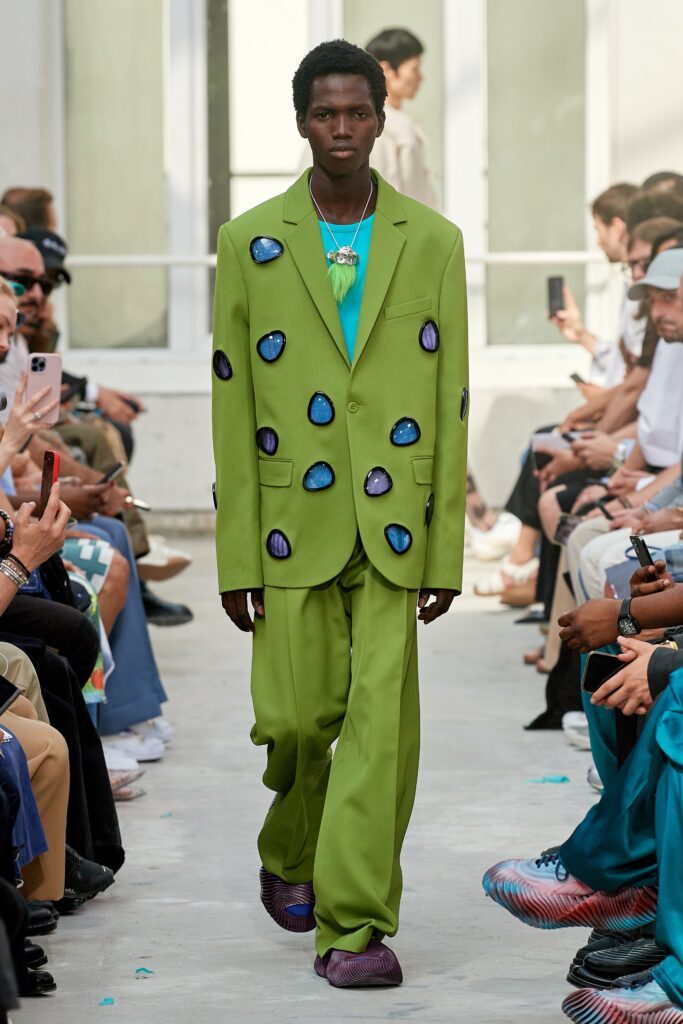 A relaxed green suit with long sleeves, a collared shirt, and a printed design.