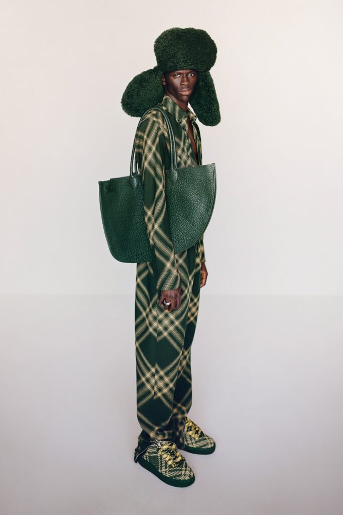 A relaxed green checked jumpsuit with long sleeves and a collared neckline.
