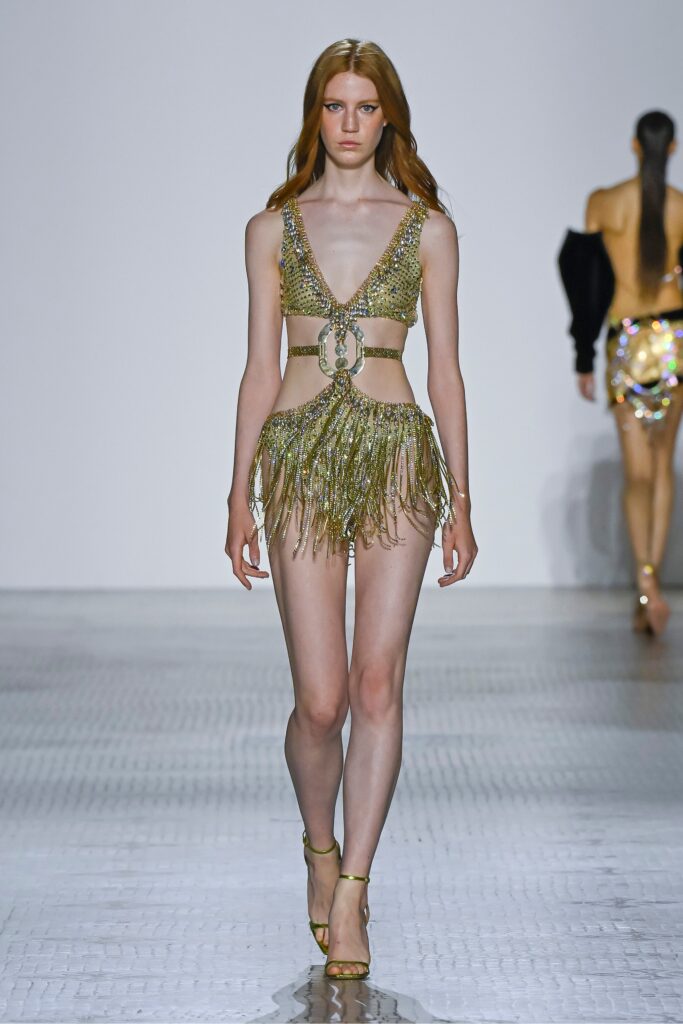 A fitted gold sequin bikini with a V-neckline and fringed detailing.