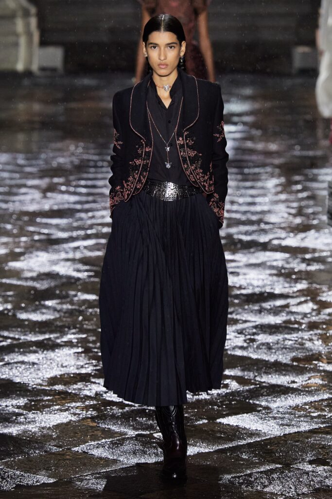 black tailored blazer and pleated skirt