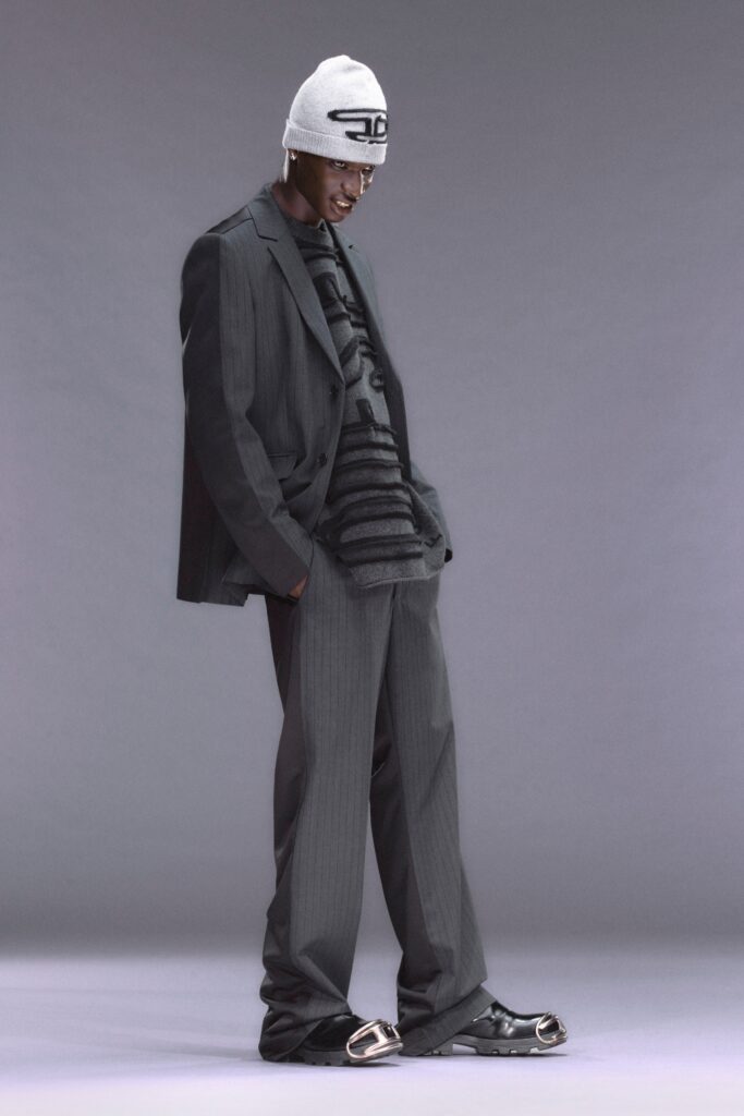 A relaxed gray suit with long sleeves and a collared shirt featuring a striped pattern.