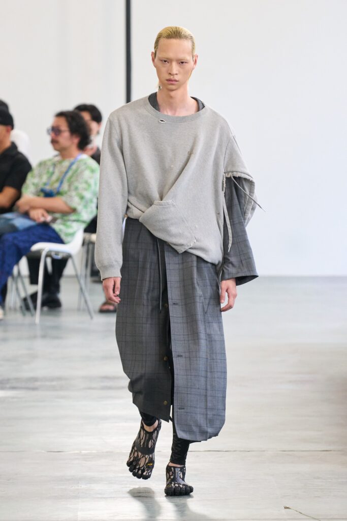 A relaxed gray long-sleeve dress with an asymmetric design detail.