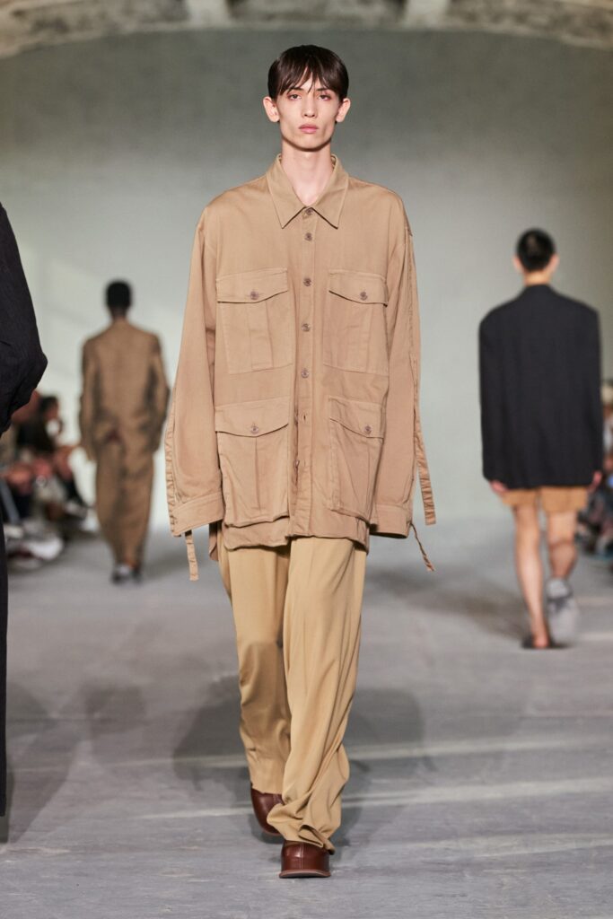 An oversized beige cotton jacket with long sleeves and collared design paired with matching pants.