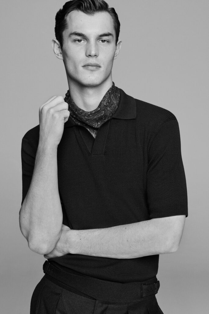 A fitted black cotton shirt with short sleeves and straight-leg pants for a sleek look.
