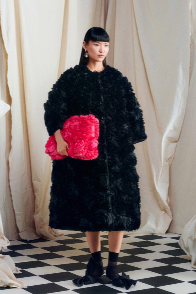 oversized black coat with pink bag