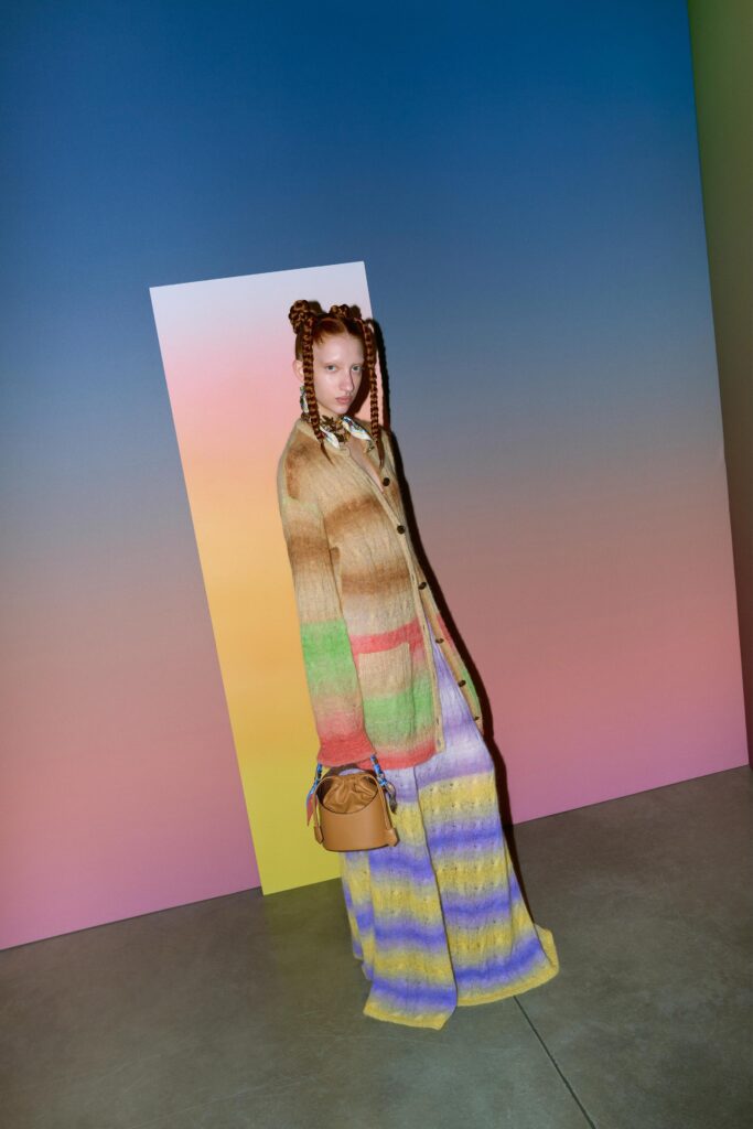 A relaxed multicolor dress with long sleeves and a collared neckline featuring a striped pattern.