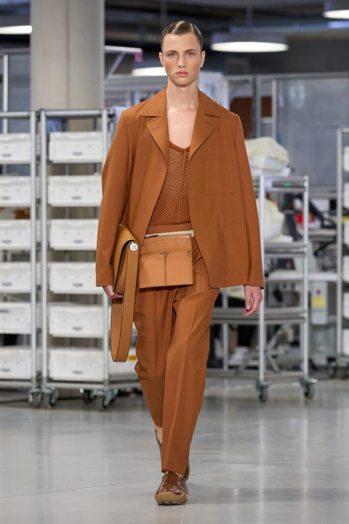 A tailored brown cotton suit with a collared long-sleeve shirt and buttoned details.