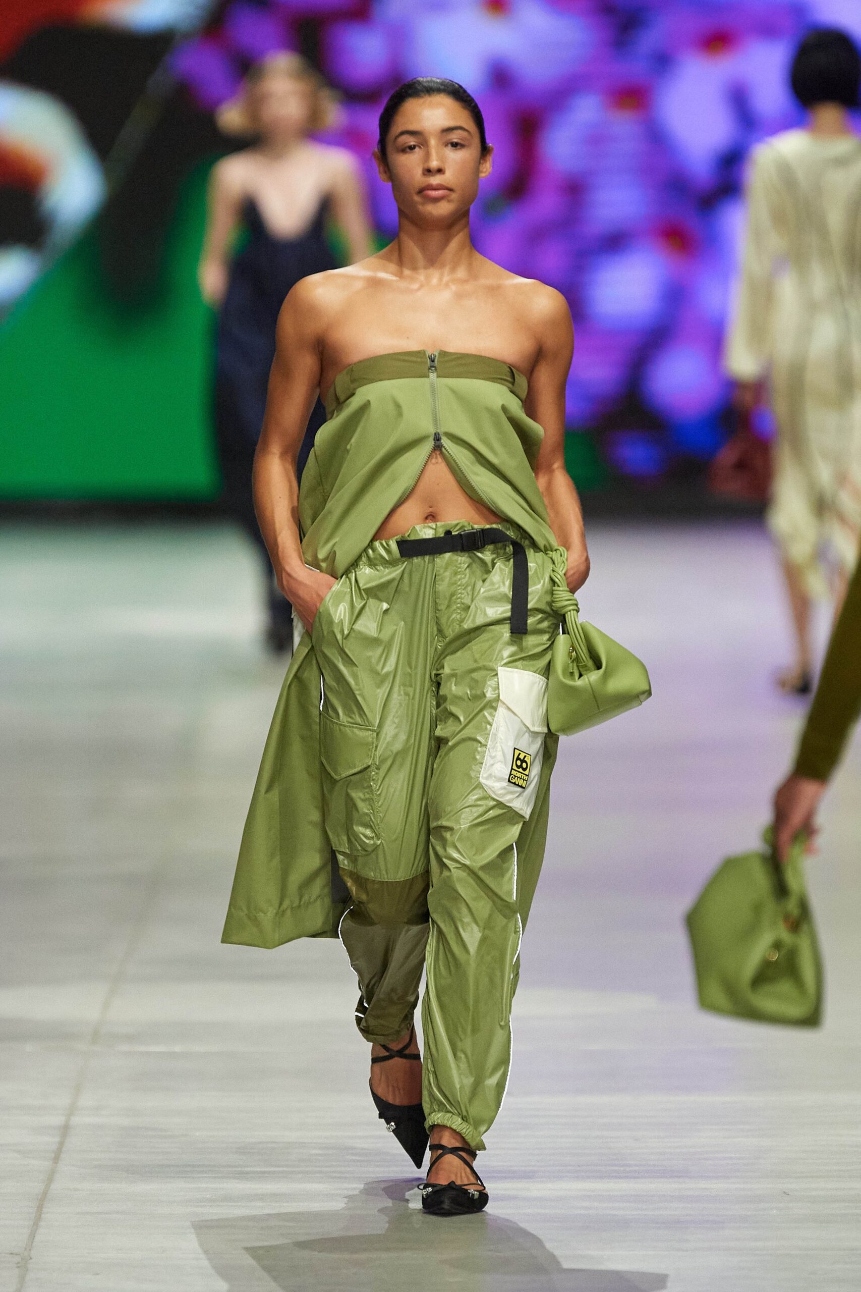 A relaxed green sleeveless top with a zippered detail paired with matching pants.