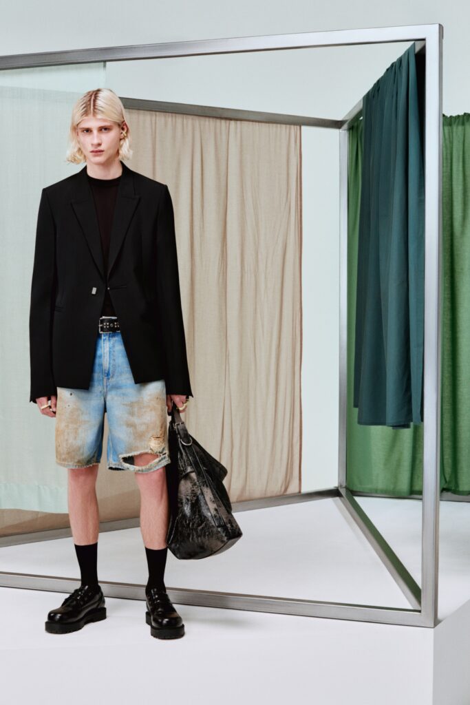 A fitted black blazer paired with distressed blue denim shorts for a modern look.