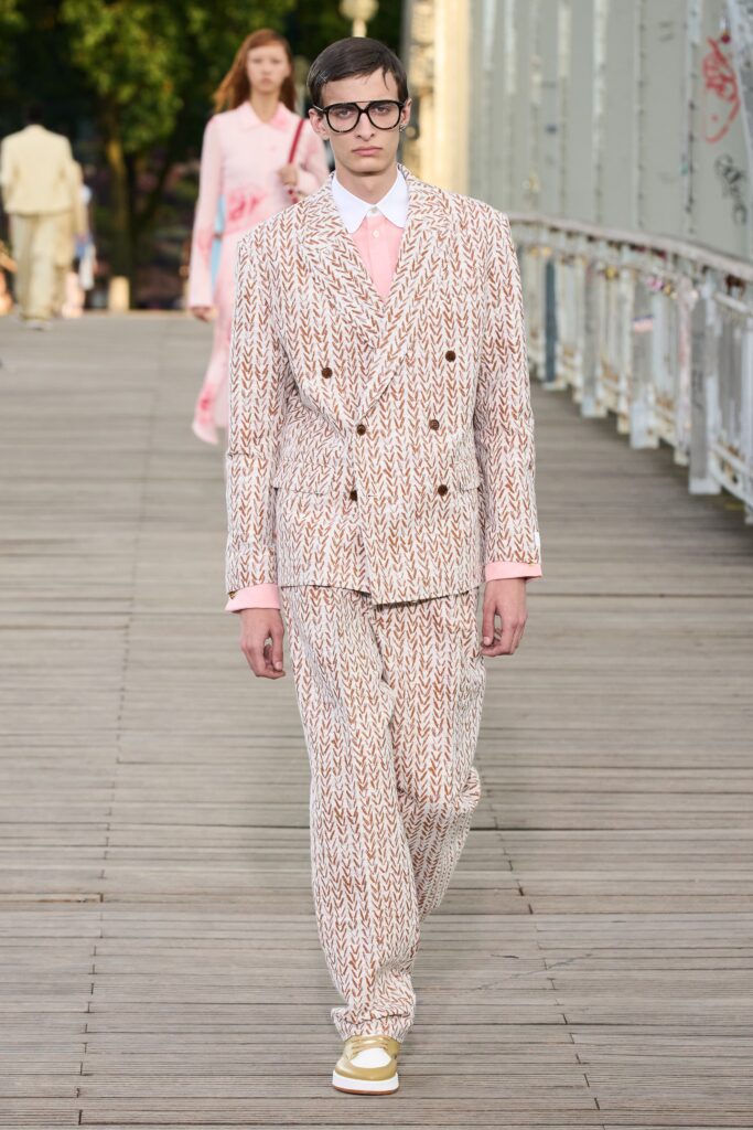 A tailored beige and brown striped suit with a collared long-sleeve shirt.