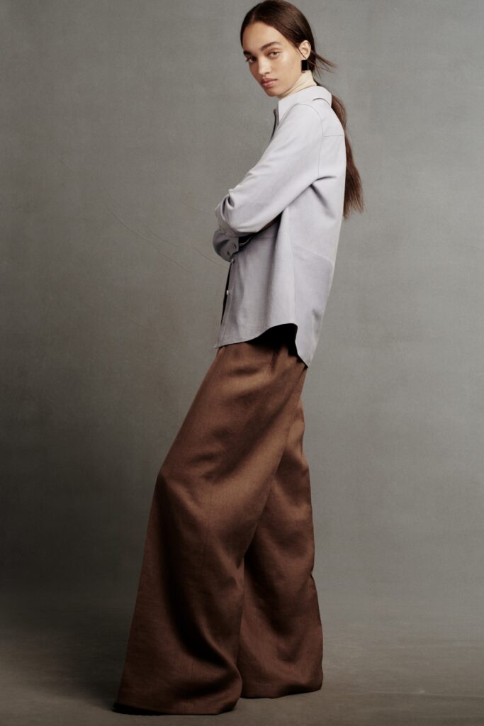 A relaxed gray collared shirt paired with wide-leg brown pants.