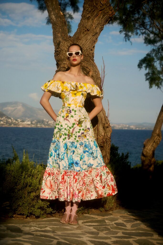 A fitted multicolor cotton dress with an off-shoulder design and tiered ruffles.