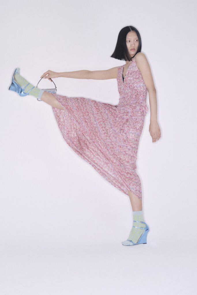 A relaxed pink cotton sleeveless dress with a V-neckline and tiered design.