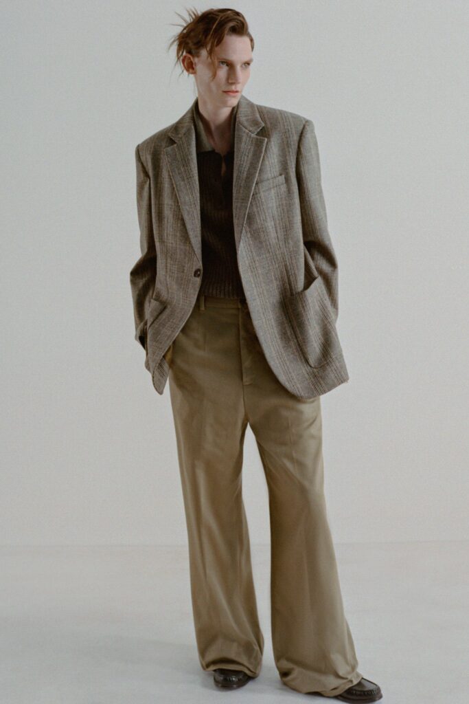 A relaxed gray cotton blazer paired with wide-leg beige pants, featuring a collared design.