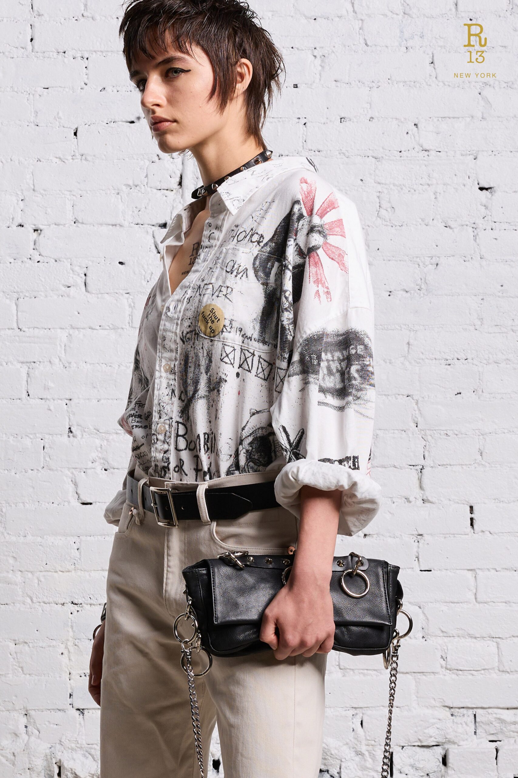 A relaxed white printed shirt paired with beige pants, featuring a collared design.