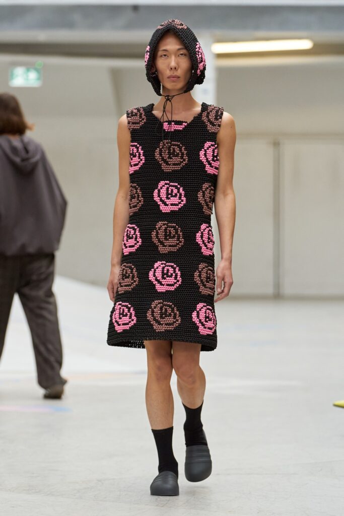 A relaxed black and pink floral dress with a sleeveless design and collared neckline.