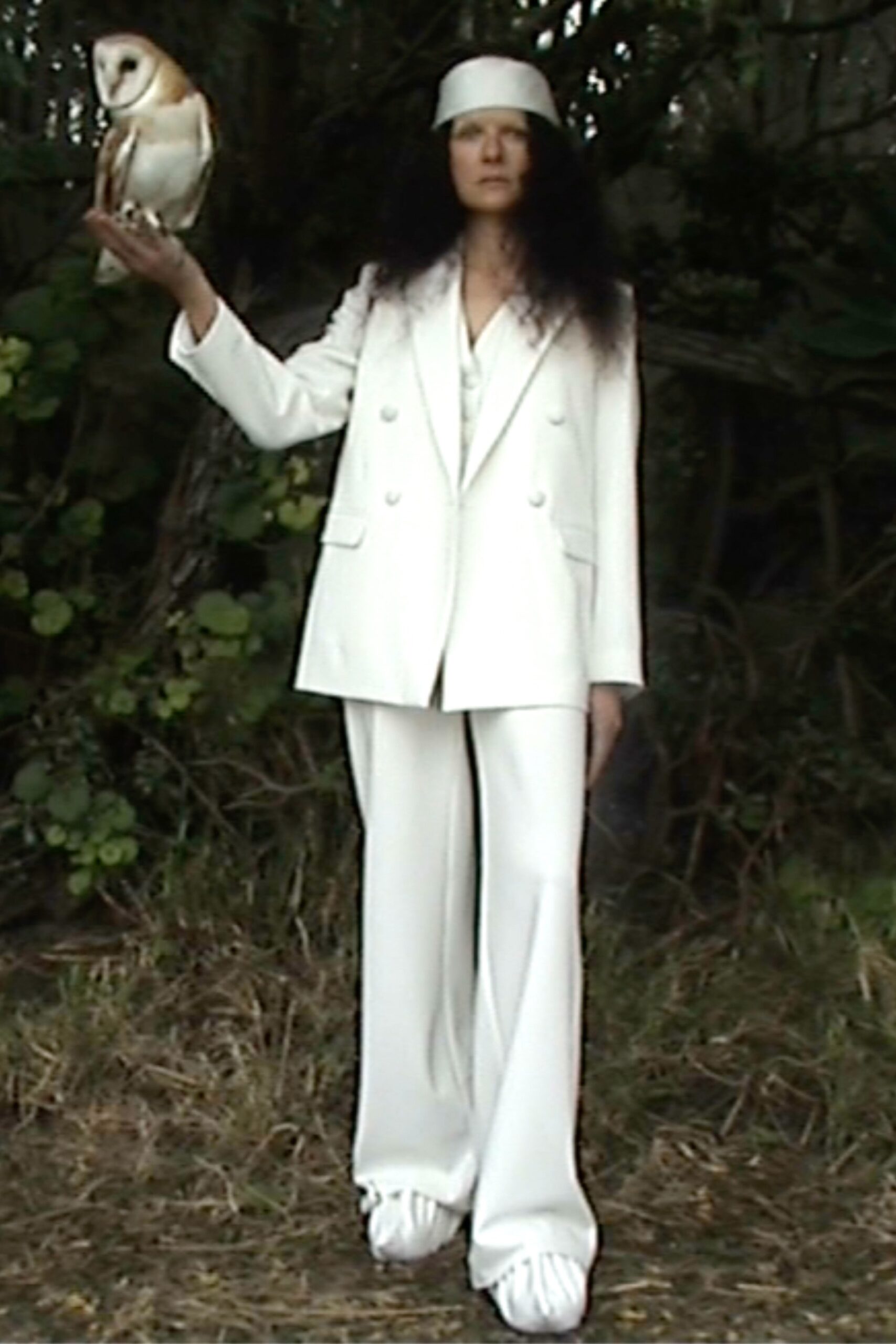 A relaxed white suit with a collared long-sleeve jacket and wide-leg trousers.