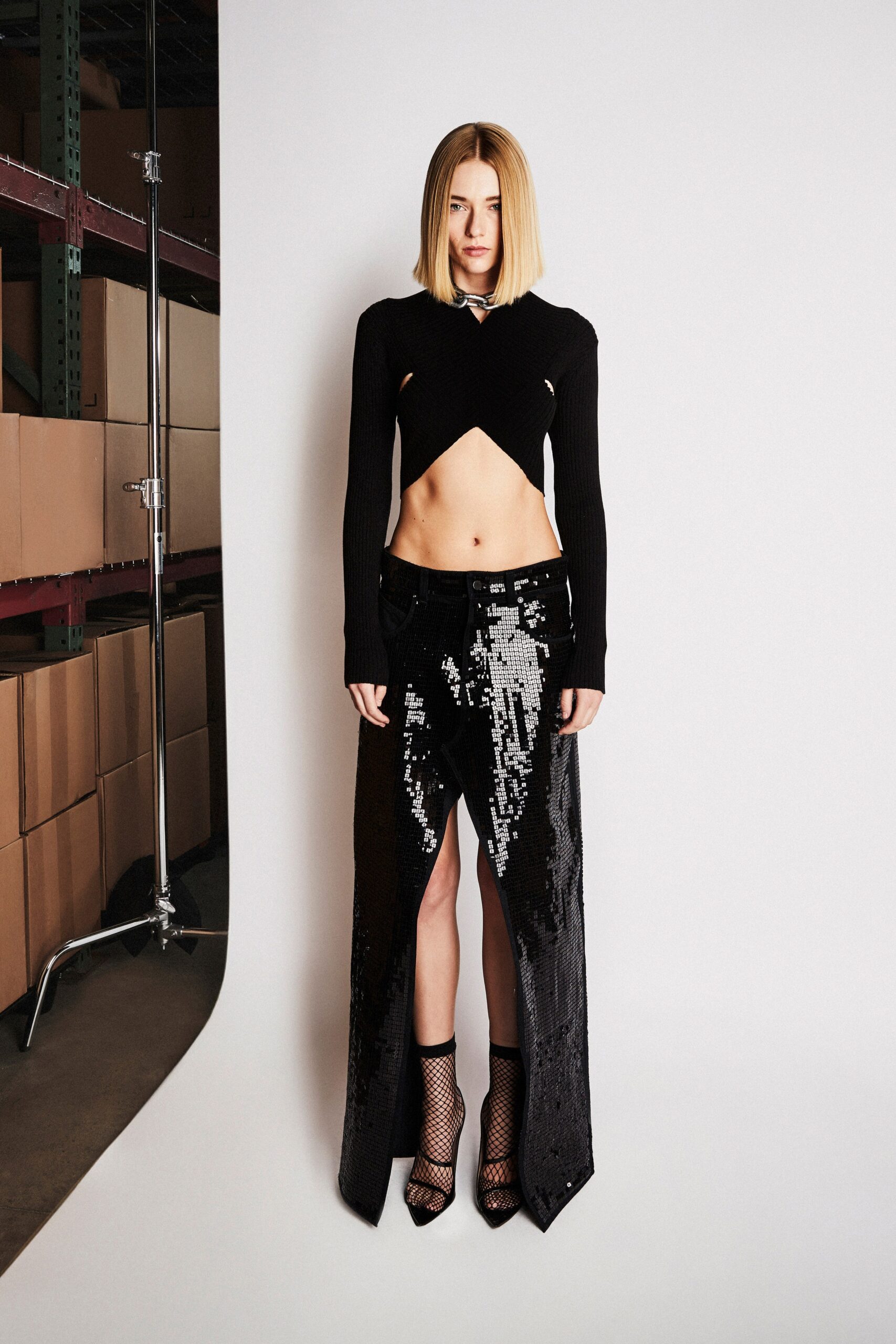 black fitted top and sequin pants