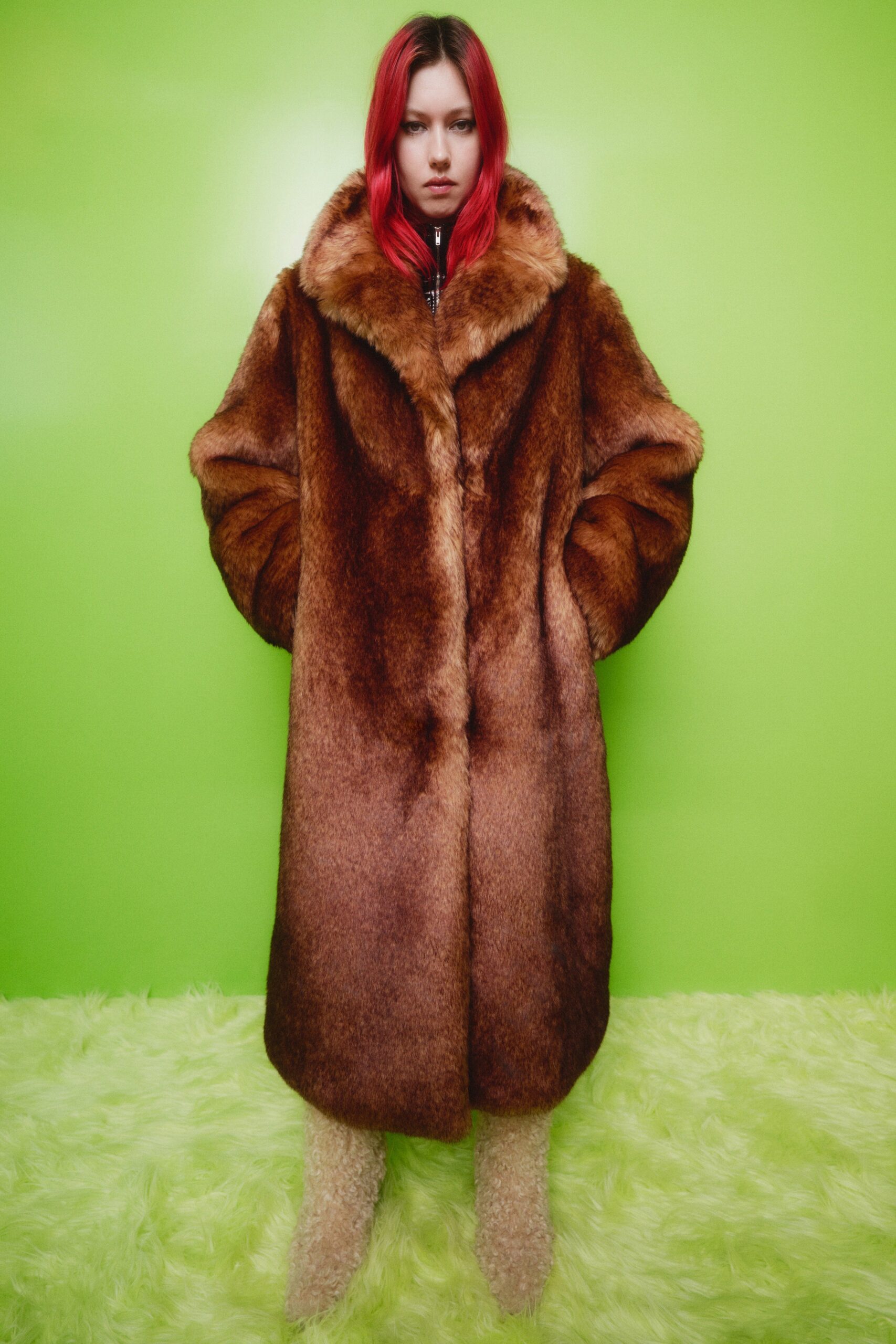 An oversized brown fur coat with a collared neckline and layered design.